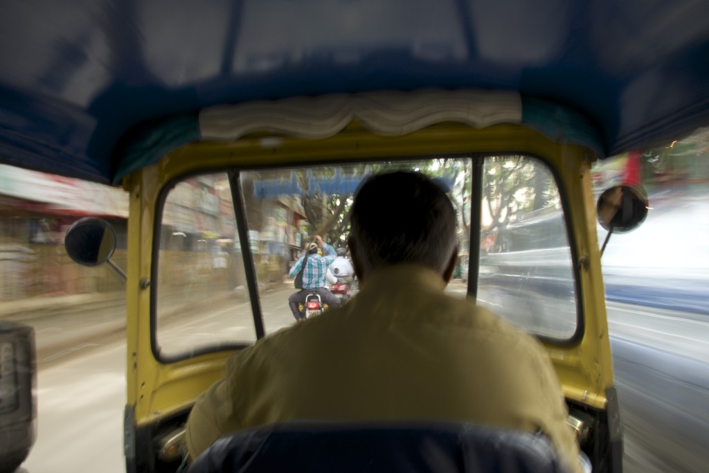 An auto rickshaw racing in the street of Bangalore, India. Although auto rickshaws are ubiquitous in many of India’s cities, in recent years, metro lines and high-speed rails are also being built or proposed across the country. 