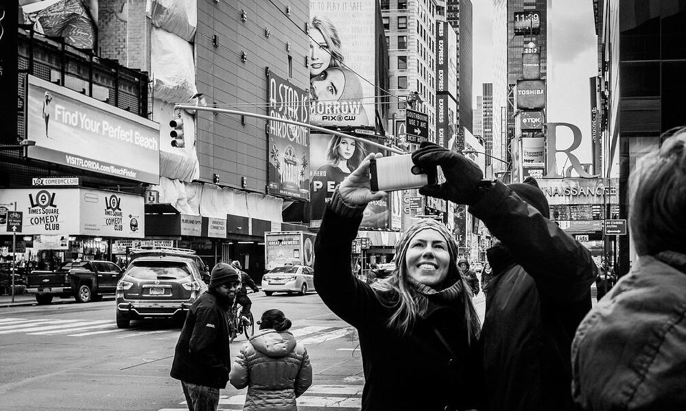Tourists taking pictures of themselves in Times Square, New York City.